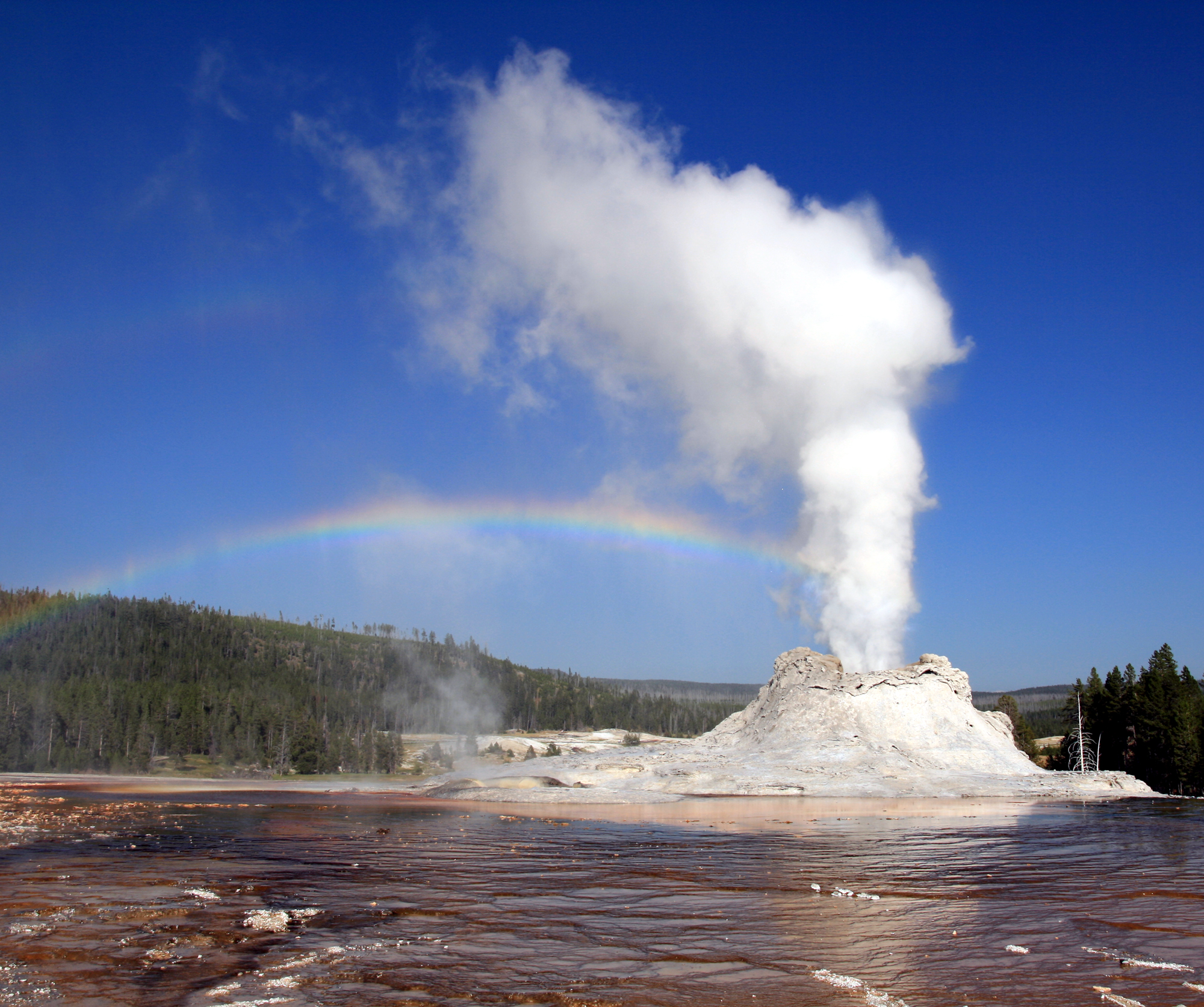 Steam Phase eruption of Castle geyser with double rainbow
